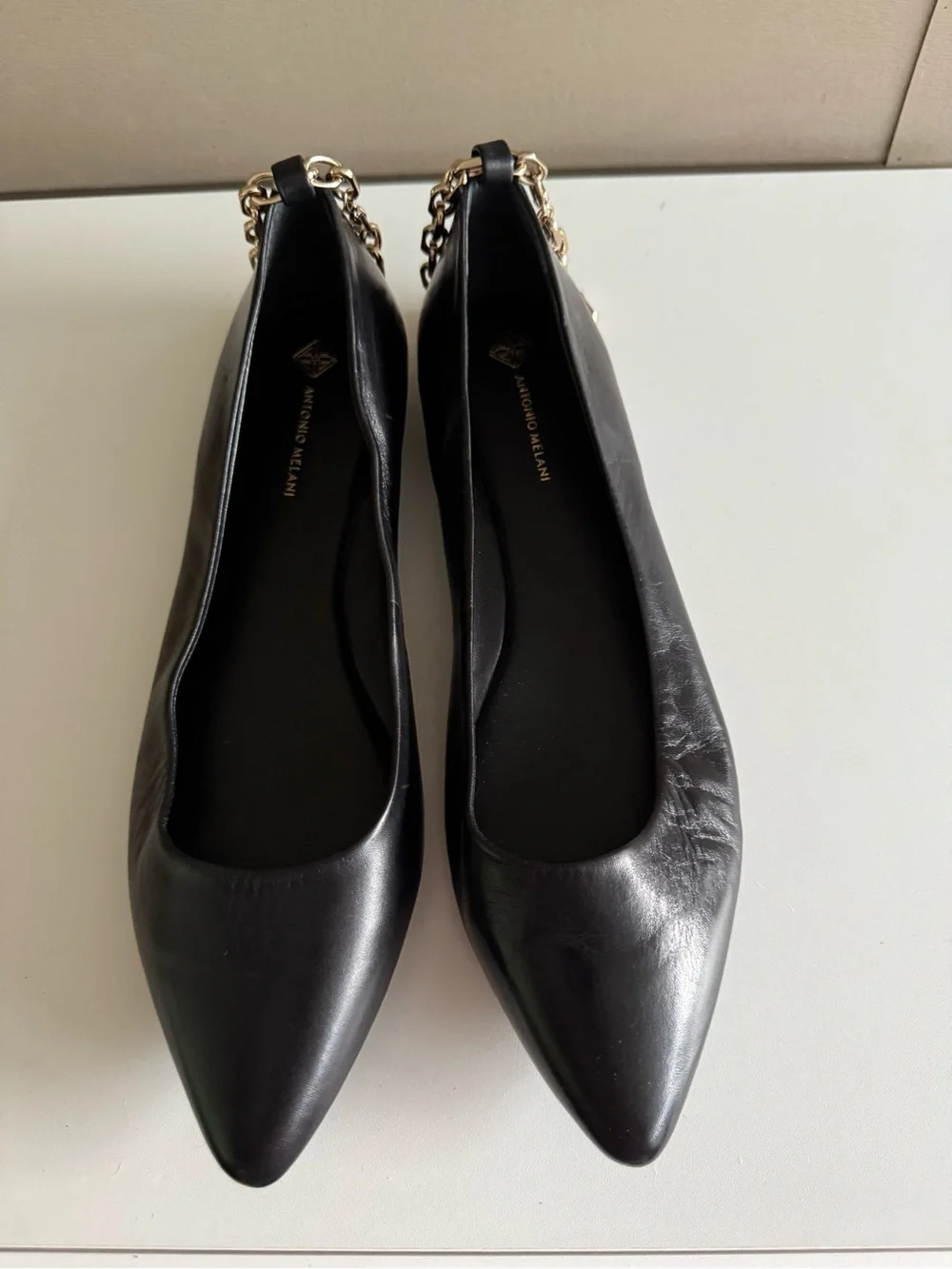 ANTONIO MELANI Black Leather Pointed-Toe Flats with Gold Chain Accent